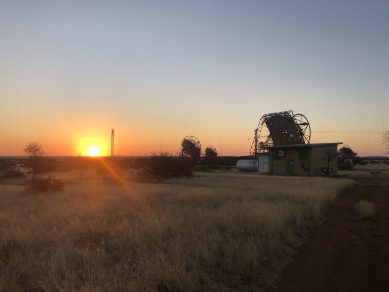 Sunset with the H.E.S.S. telescopes in the foreground. Image credit: Lars Mohrmann